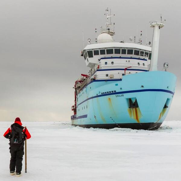 Ethan Roth observers the RV Sikuliao as it carves through the ice in Alaska